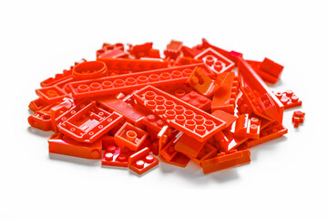 Red plastic toy bricks blocks on white background. Educational toy for children. Education concept