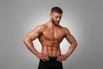 Fototapeta na wymiar Young bodybuilder with muscular body on light grey background