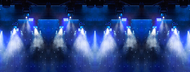 An empty stage of the theater, lit by spotlights and smoke before the performance