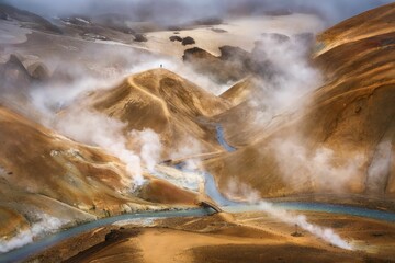 Scenery of tourist man walking in the morning on the top of Kerlingarfjoll mountain in geothermal...