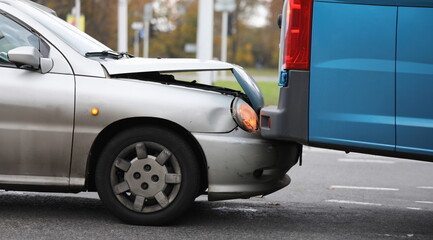 Focus on damaged bumper of vehicle in car accident in city. Damaged parts of transport. Automobile with breakdown and crashed details. Collision of auto on road
