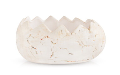 flower pot in the shape of a broken dinosaur egg is highlighted on a white background