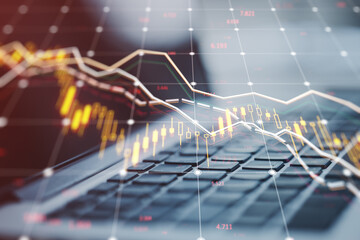 Stock market decline graph overlaying a laptop keyboard