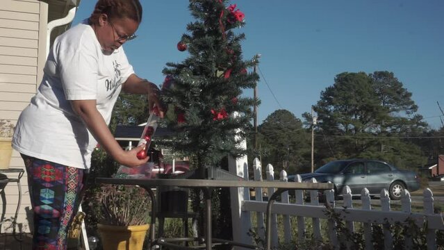 Black Woman Happily Decorating Christmas Tree