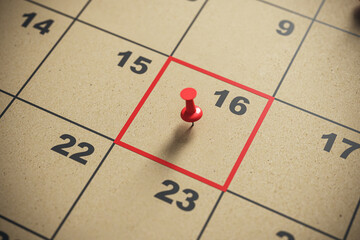 Close-up of calendar with red pin on date 16, concept of important appointment. Scheduling and...