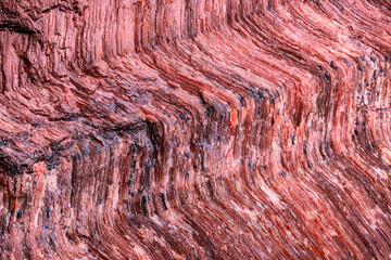 bull's eye (red tiger's-eye) macro detail texture background. close-up raw rough unpolished semi-precious gemstone
