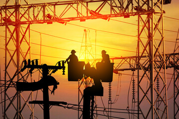 silhouette group of electrician engineer on cradle of aerial platform or crane worked over rate in electric constrution site on sun setabstract nature background, tecchnology concept - obrazy, fototapety, plakaty