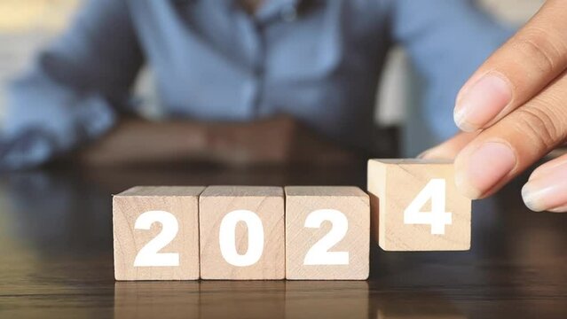 Changing wooden blocks from 2000 to 2024 idea, business, goals, resolutions, strategy, roadmap, startup company, budget, mission, motivation, calendar, growth, success, Christmas and Happy New Year.