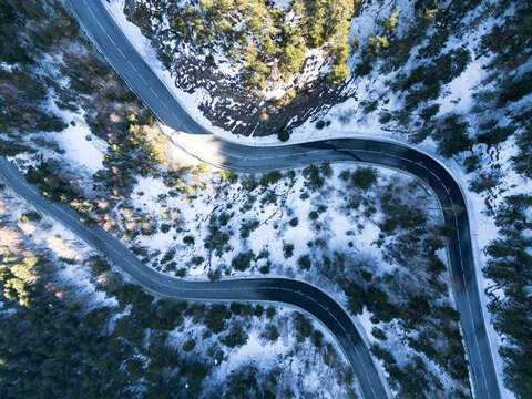 Aerial view of a snowy mountain road in the Pyrenees of Andorra in the winter