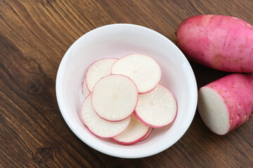 Fresh Red Radish (Lobak Merah) on wooden background.
