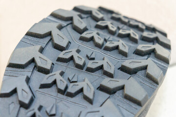 Rubber sole of hiking modern boots close-up