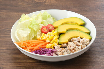 Healthy Salad Bowl, mix vegetables carrots, lettuce, cabbage, potatoes, chicken and avocado
