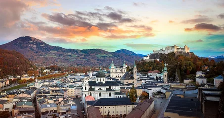 Fototapeten Autumn season at a historic city of Salzburg with Salzach river in beautiful sunset sky and colorful of autumn scene Salzburger Land, Austria © SASITHORN