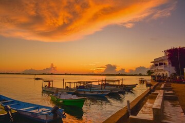 Fototapeta premium Boats against beach front properties at sunset in Shela Beach, Lamu Isand, Kenya