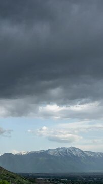 Vertical Timelapse of storm clouds moving over Utah Valley viewing Loafer Mountain and Mt. Nebo in the background.