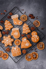 Beautiful delicious sweet winter Christmas gingerbread cookies on a gray textured background