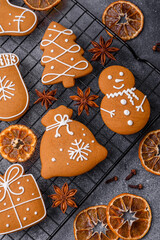 Beautiful delicious sweet winter Christmas gingerbread cookies on a gray textured background