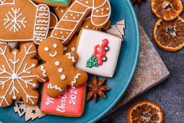 Beautiful delicious sweet winter Christmas gingerbread cookies on a gray textured background