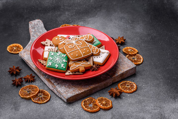 Beautiful delicious sweet winter Christmas gingerbread cookies on a gray textured background