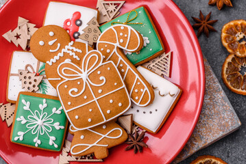 Beautiful delicious sweet winter Christmas gingerbread cookies on a gray textured background