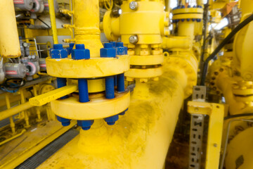 Oversized flange, large tube painted yellow with lots of bolts and nuts painted blue.