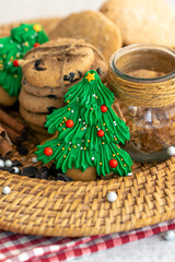 Gingerbread in the shape of a Christmas tree and cookies in a wicker plate.