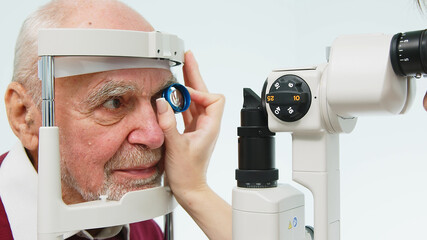 An ophthalmologist checks the vision of an elderly person using modern equipment. The concept of...