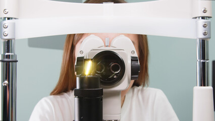 Medical ophthalmological device for testing vision. Ophthalmologist working with testing patient's...