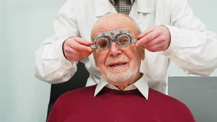 Happy elderly man consulting with an ophthalmologist. Medical ophthalmological care. Close-up of a...