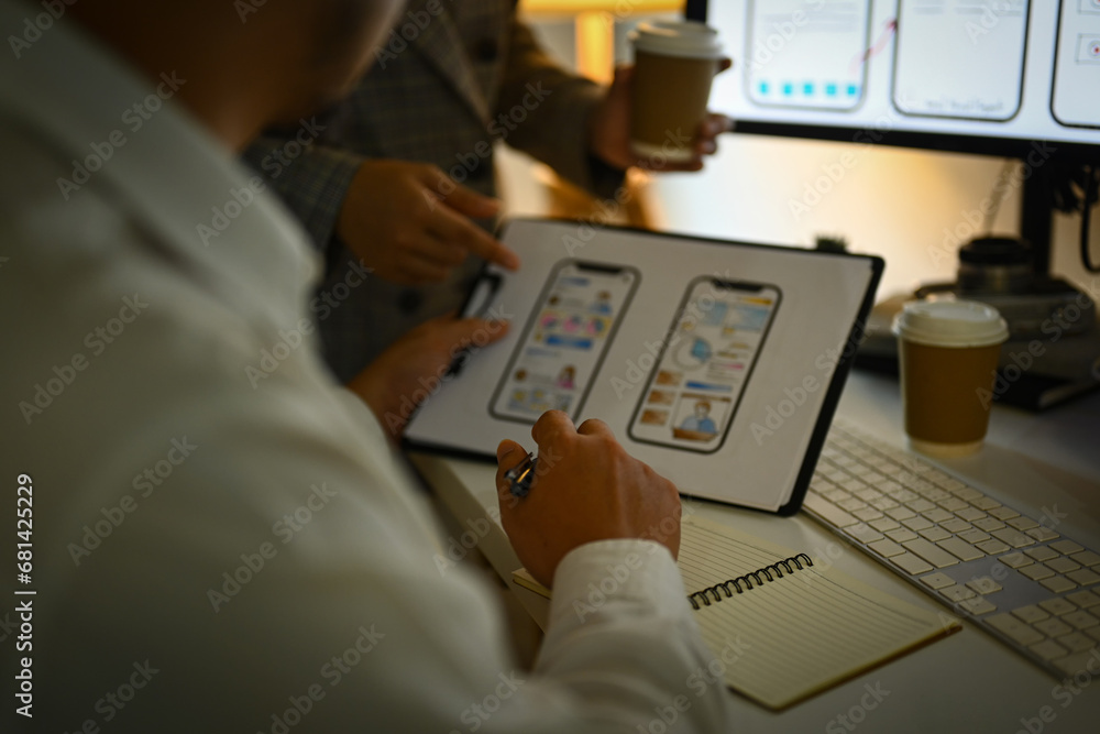 Poster cropped shot of developers team working on new website wireframe at office