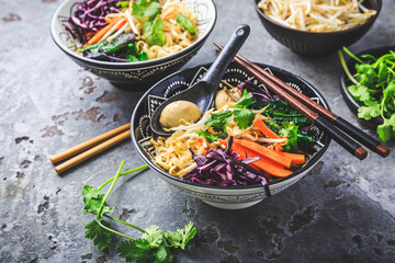 Vegan miso noodle soup with mushrooms, red cabbage, carrots and sprouts - obrazy, fototapety, plakaty