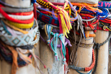 Colourful bracelets left by visitors at the site of a mass grave, Choeung Ek Killing Fields Genocide Centre, Phnom Penh, Cambodia