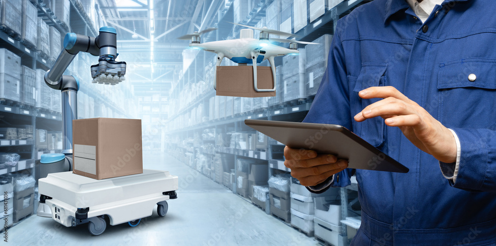 Poster manager with digital tablet in an automated warehouse with robots and drones.
