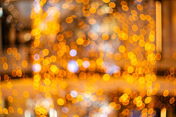 Blurred holiday background with bokeh. Defocused New Year and Christmas illumination