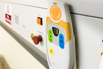 Bed head unit in a hospital ward showing an emergency red pull call bell and an electrostatic discharge point.
