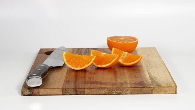 Freshly sliced orange on a wooden cutting board.