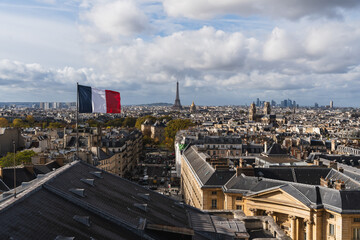Paris skyline panorama with the Eiffel Tower and French flag