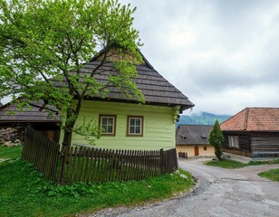 Fototapeta na wymiar Vlkolinec, typical and traditional settlement village in mountains with preserved log cabin houses with colorful walls facades listed in UNESCO world heritage in Slovakia , spring day