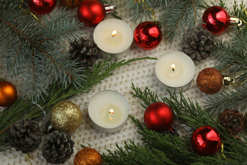 White knitted background with christmas decoration and candles