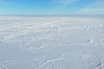 Top view of the ice field. Aerial view of a field covered with snow. 