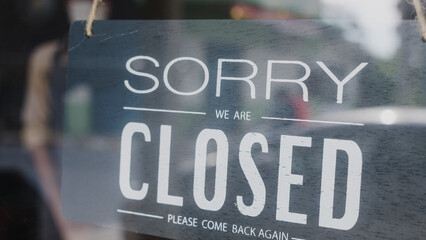 Sorry we're closed vintage black and white retro sign on a coffee glass door cafe after coronavirus...