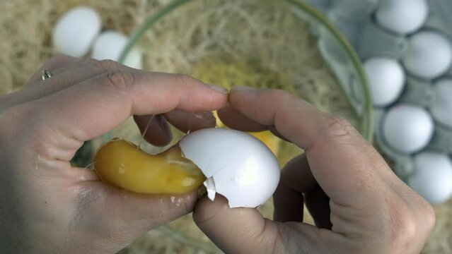 Breaking egg mishap, close-up hand cracks egg gone wrong, slow-motion at 800 fps