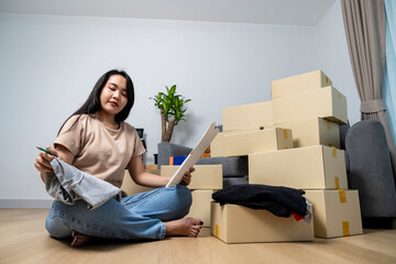 The young woman is packing her belongings in preparation for moving
