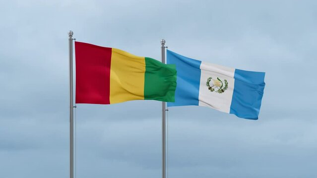 Guatemala flag and Republic of Guinea flag waving together on cloudy sky, endless seamless loop, two country relations concept