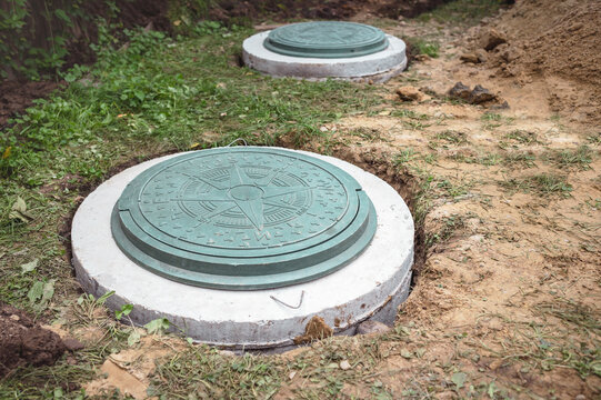 Manhole of Septic Tanks System. Concrete Sewage Well Installing Underground of Country House.