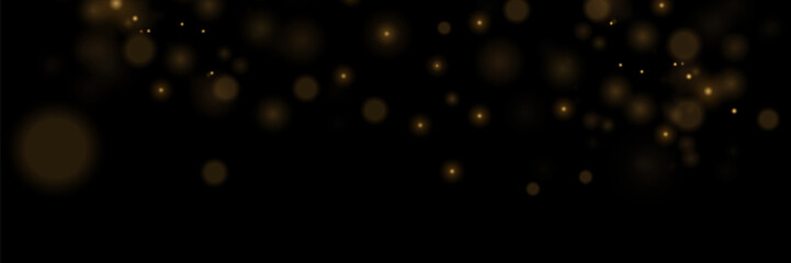 Light abstract glowing bokeh lights. Bokeh light effect on a black background. Festive golden glowing background.