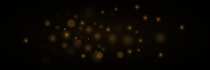 Light abstract glowing bokeh lights. Bokeh light effect on a black background. Festive golden glowing background.