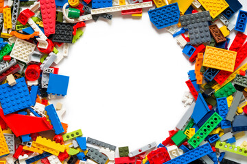 Naklejka premium Toy Brick Stack Creating Border on White Surface. Copy space for text. Lego blocks. Novosibirsk, Russia - October 26, 2023.