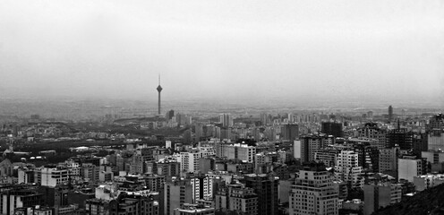 a city skyline and mountain is shown in black and white