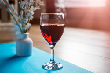 Red wine in a glass on a blue napkin on a light background